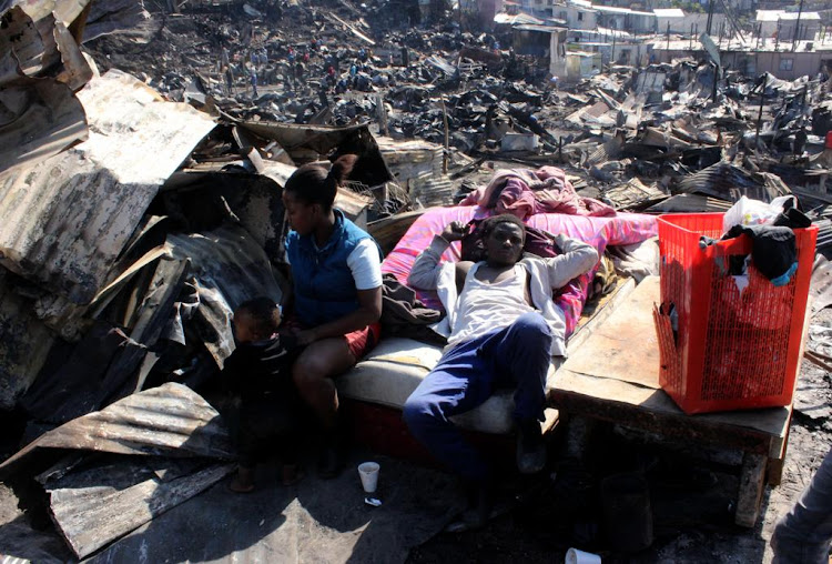 Residents of the Kennedy Road informal settlement prepare to sleep out in the open as they don't have a place to stay.