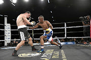 Gift 'Sheriff' Bholo connects on Timo Schwartzkopf of Germany in their six-rounder which Bholo won on points. / Nick Lourens