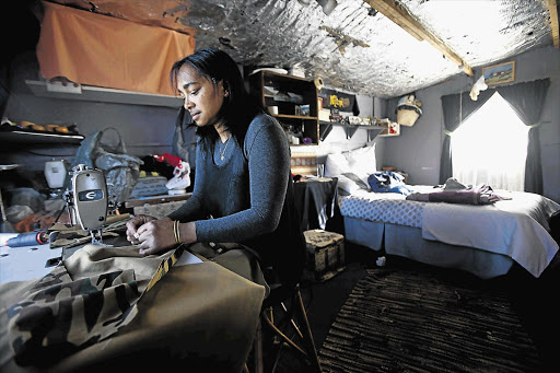 Janina Samuels at work in her small two-bedroom house built high above Hout Bay harbour. The municipality is trying to evict her
