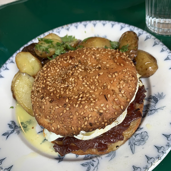 The egg breakfast sandwich with potatoes.