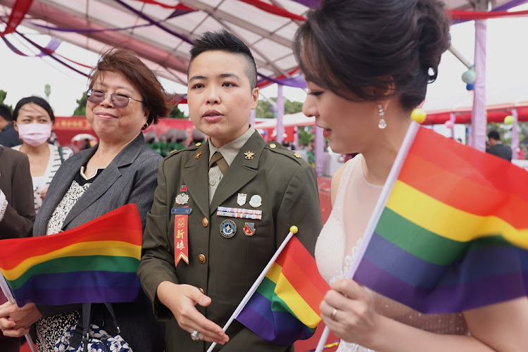 Wang Yi, a political warfare major from the army, and her wife Meng Yu-Chen, speak to the media during a military mass wedding in Taoyuan, Taiwan, October 30, 2020.