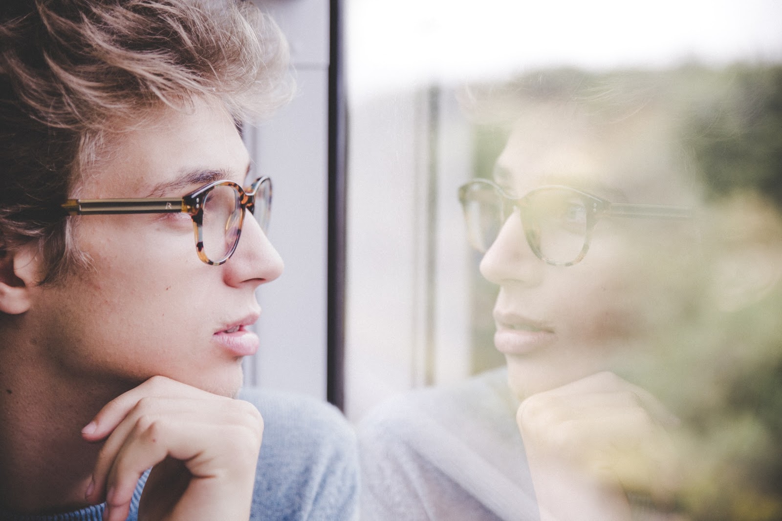 Man thinking by the window.