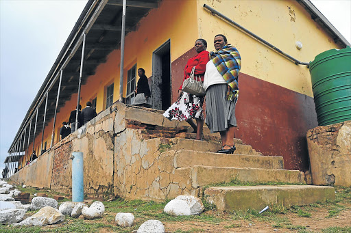 DESPERATE MEASURES: Lower Esinxaku JSS head of department NomIndia Jokazi, left, and principal Linda Qhayiyana in the dilapidated school building in a poverty-stricken rural village near Tsolo Picture: LOYISO MPALANTSHANE