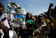 Supporters of the ruling Zanu-PF party of President Emmerson Mnangagwa celebrate following general elections in Harare, Zimbabwe, July 31, 2018. 