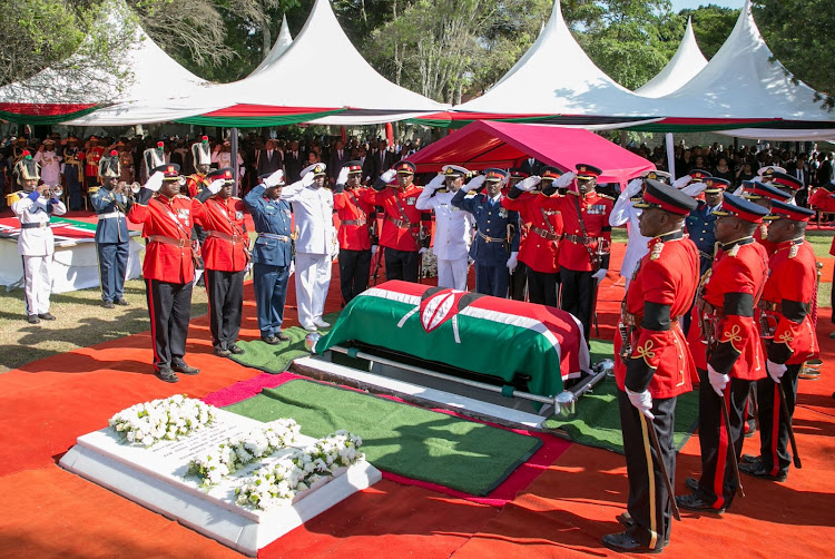 Members of the Kenya Defence Forces (KDF) salute the coffin of late former Kenya's President Daniel Arap Moi, draped with the national flag, during the burial at his Kabarak home in Nakuru county, Kenya February 12, 2020.