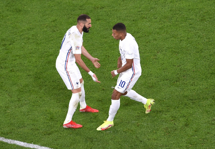 France's Karim Benzema celebrates scoring their first goal with Kylian Mbappe.