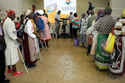 Pensioners queue to collect their grants at a Sassa pay point. File image