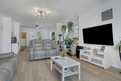 Living room with sofa, television and coffee table in this luxury property for sale in East Orange ($599,000)