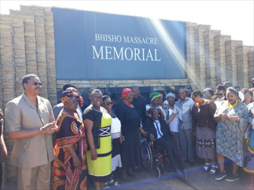 Premier Phumulo Masualle at the Bhisho Massacre Memorial with families who lost their loved ones during the tragedy Picture: ZINGISA MVUMVU