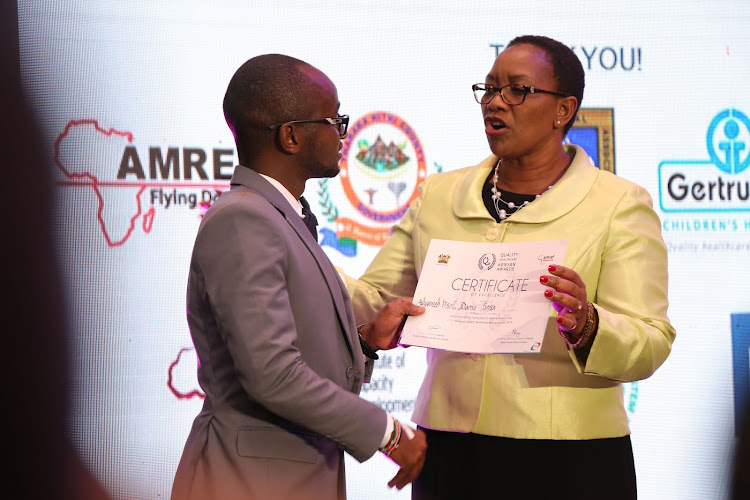 Health CS Sicily Kariuki hands over certificate of excellence to Francis Kilema from Damu-sasa during the Quality Health care awards on July 3, 2019