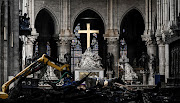 A picture shows rubble and the cross at the altar inside the Notre-Dame Cathedral in Paris, France, on May 15 2019 after it sustained major damage in a fire in April. After the fire Russian media outlets in Europe blamed Islamist militants and Ukraine's pro-Western government.