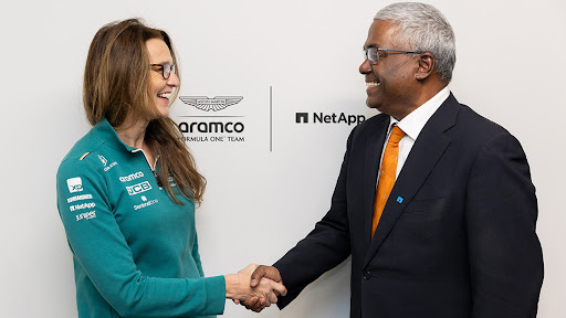 Clare Lansley (left), CIO of Aston Martin Aramco and George Kurian (right), CEO of NetApp, shake hands to celebrate their companies’ partnership renewal. (Photo: Business Wire)
