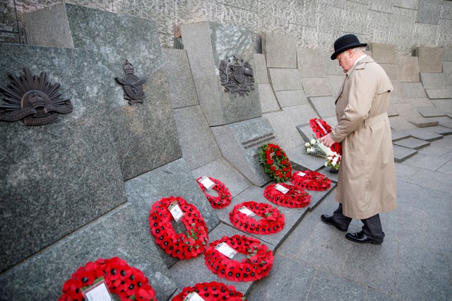 A member of the public lays a wreath during the Dawn Service at Wellington Arch to commemorate Anzac Day in London, Britain, April 25, 2018.