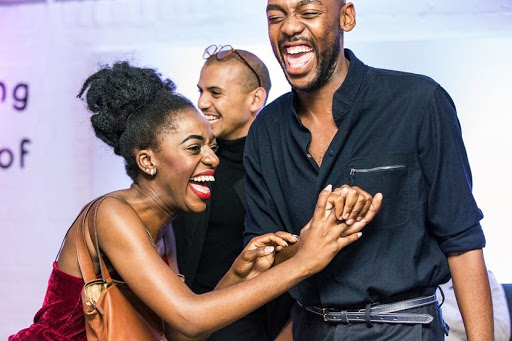 Suzy Mukendi and Rich Mnisi crack each other up during the #ForeverChuck, Converse event at Museum of African Design in Maboneng on March 09, 2017 in Johannesburg, South Africa. Photographer and an all-round creative Fhatuwani Mukheli and assorted influencers customised their many Converse sneakers with, in some cases, the help of professionals. (Photo by Gallo Images / The Times / Mariska van den Brink)