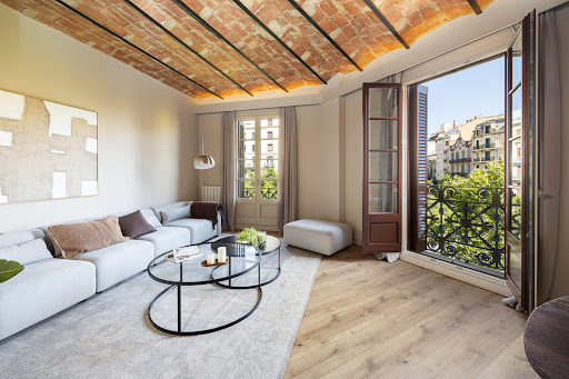 Modern living room with exposed beams and city view in this luxury apartment / penthouse for sale in Barcelona ($2,183,554)