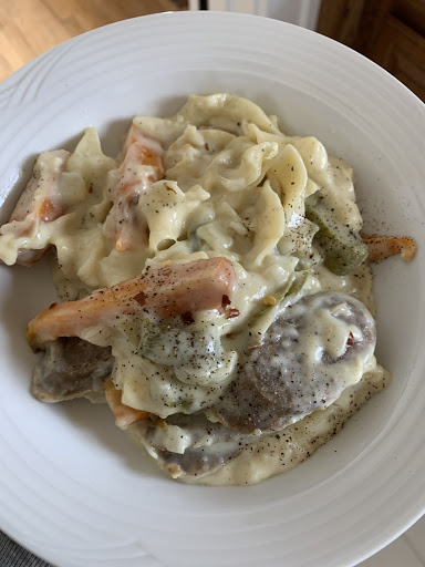 Creamed Bratwurst with onions, green peppers, roasted carrots and noodles.