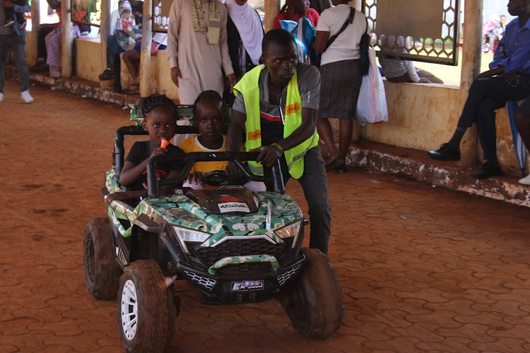 Children riding a bike during the Eid Mubarak celebrations at Uhuru Park, Nairobi on April 10, 2024.