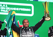 Mercedes' Lewis Hamilton celebrates with the trophy on the podium after winning the Brazilian Grand Prix at the Jose Carlos Pace Circuit, Sao Paulo, Brazil, on November 14, 2021