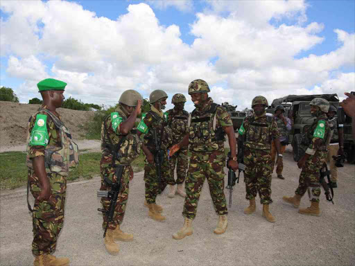 KDF commander in Somalia Brigadier Joakim Mwamburi greets officers at Sector 2 Forward Operation Base in Tabda / RAMADHAN RAJAB