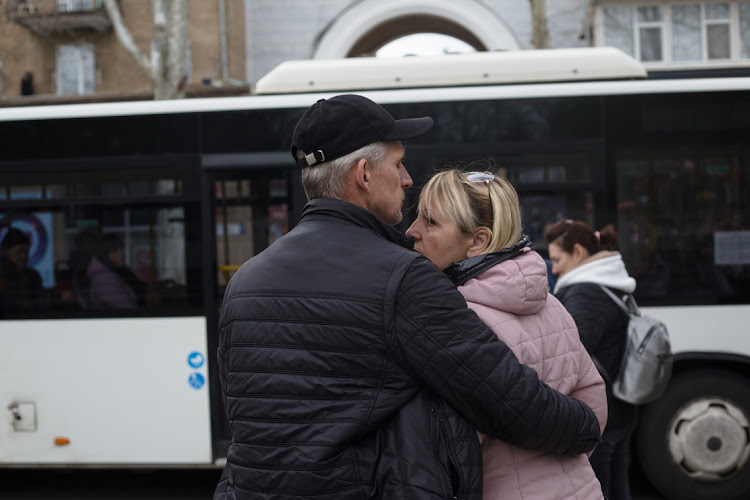 People hug before leaving the city in an evacuation bus on April 23, 2022 in Mykolaiv, Ukraine. Mykolaiv, a port city near where the Southern Bug flows into the Black Sea, has been a target of Russian attacks throughout its current invasion of Ukraine. Ukrainian forces here repelled an initial advance from Russian-held territory nearby, but the city has experienced frequent shelling and air strikes even as Russia shifts the focus of its war to the eastern Donbas region.