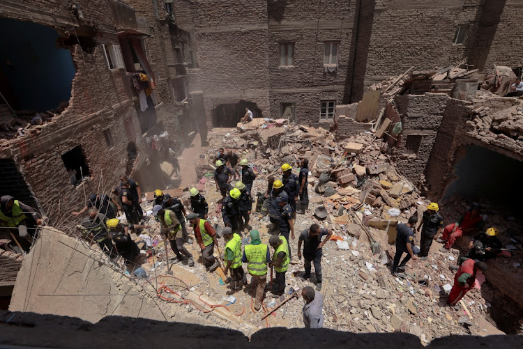 Egyptian emergency and rescue personnel search for survivors in the rubble of a five-storey apartment building that collapsed, leaving several people dead, according to authorities, in Hadaeq al-Qubbah neighborhood, in Cairo, Egypt, on July 17 2023.