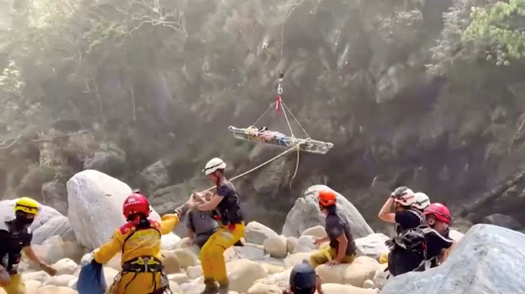 Rescuers assist as a helicopter lifts an injured person on a stretcher, following the earthquake, in Hualien, Taiwan, April 4 2024. Picture: PINGTUNG FIRE DEPARTMENT/REUTERS