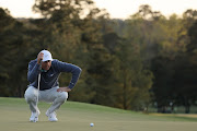 Scottie Scheffler lines up a putt on the 18th green during the third round of the Masters at Augusta National Golf Club in Augusta, Georgia on April 9 2022.