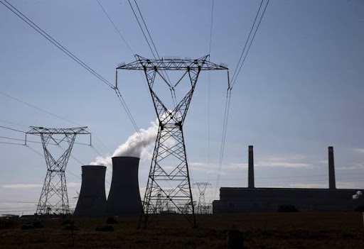 Electricity pylons are seen near Arnot Power Station's cooling towers, east of Middelburg in Mpumalanga province, September 8 2015.