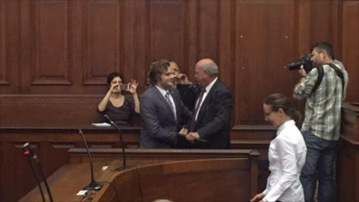 Henri van Breda greets his uncle, Andre, in the High Court in Cape Town.