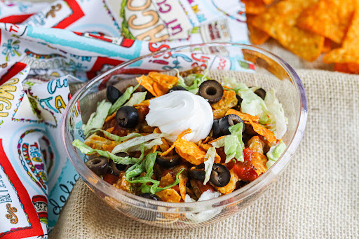 Super Bowl Taco Showdown topped with Doritos, sour cream, and black olives.