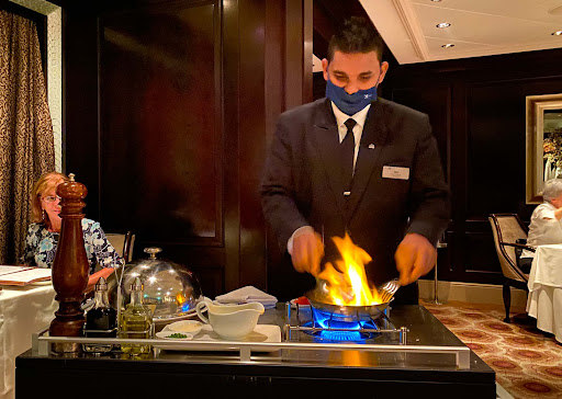 preparing-lobster-dish-at-murano.jpg - A server prepares a flaming lobster dish at Murano.