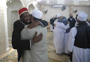 Muslims greet each other after the  Eid ul Fitr prayer at the Mountview Mosque in Cape Town.