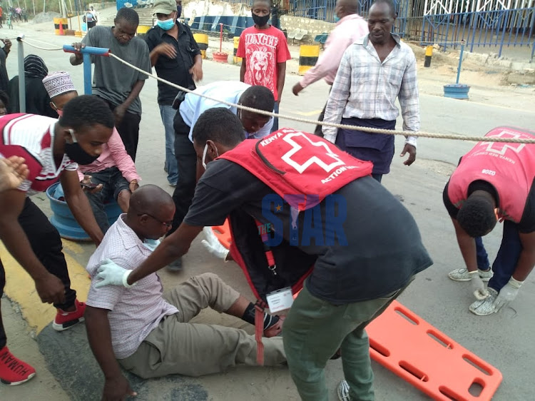 Red Cross officials help the injured at the Likoni Crossing Channel on July 21, 2020.