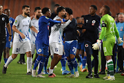 Muerasimballah Al Taeb of Al Hilal Benghazi protests to Ricardo Goss of SuperSport United during the Caf Confederation Cup match at Peter Mokaba Stadium in Polokwane on Wednesday night.