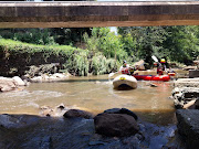 Divers navigate the Jukskei River on Tuesday searching for missing victims.