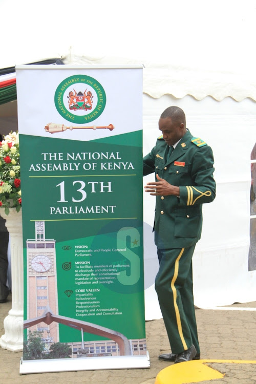 A sergeant-at-arms makes preparations before MPs orientation at Parliament Buildings on August 25 2022.