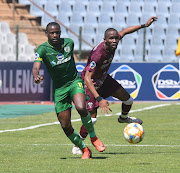 Manqoba Zungu of Swallows FC challenges Dan Ndlovu of Baroka FC during the 2021 DStv Diski Challenge match between Swallows FC and Baroka FC don the 10 April 2021 at Dobsonville Stadium.