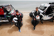 Saudi female rally drivers Mashael Nasser Al-Obaidan and Dania Akeel next to their Buggies during the first stage of Sharqiyah International Baja Rally in Dhahran, Saudi Arabia on March 5 2021.