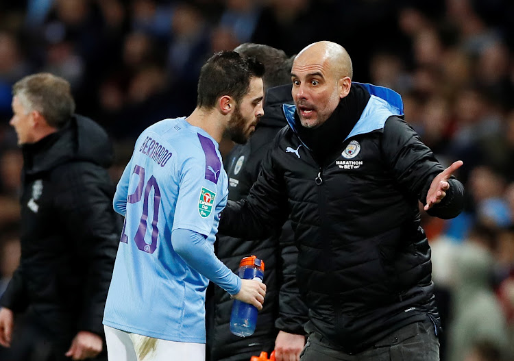 Manchester City manager Pep Guardiola with Bernardo Silva