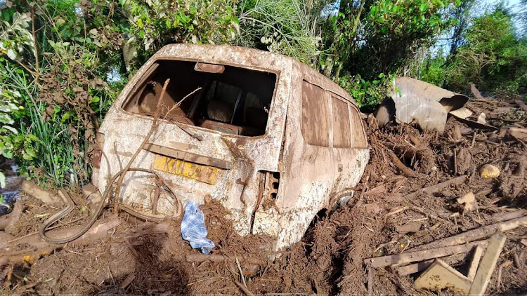 A car stuck in mud and debris after a river broke banks and wrecked havoc in Kamuchiri Village in Mai Mahiu, Nakuru County on April 29, 2024.