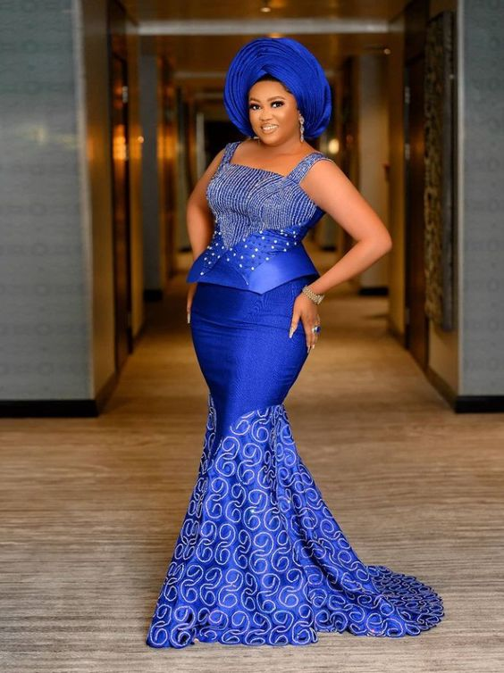 lady wearing blue mermaid mermaid dress with matching gele