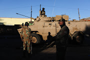 Members of the South African Defence Force patrol in Alexandra, Johannesburg. 