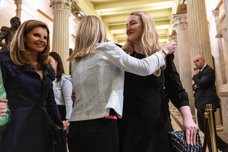 Kate Cox, a mother from Texas who had to travel out of state for a medically necessary abortion, receives a hug following the State of the Union address to a joint session of Congress in Washington, U.S., March 7, 2024.