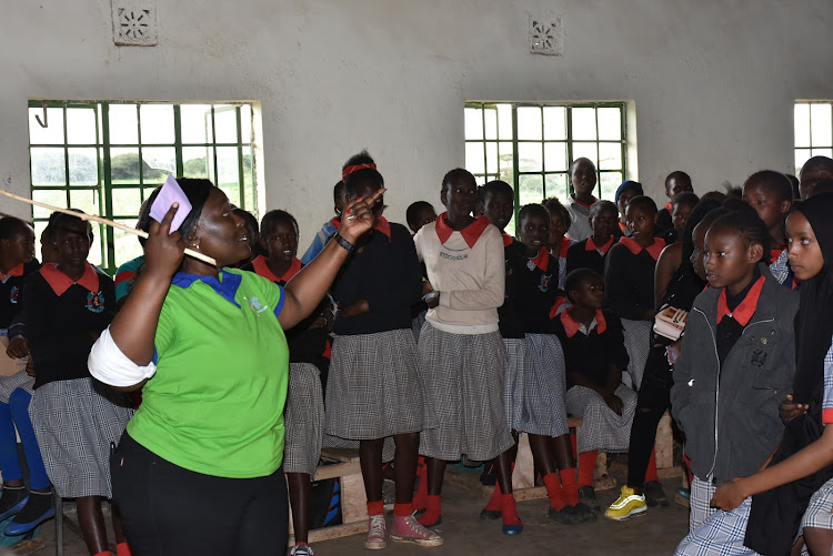 Evelyn Mbinya from Mavel Five teaches the pupils how to use a sanitary towel