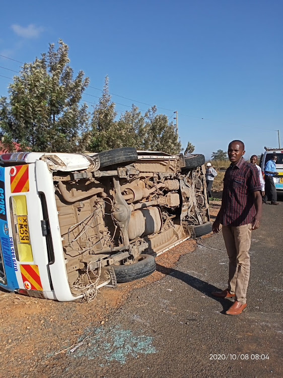 The 14-seater matatu after it overturned along the Mbumbuni Machakos road on Thursday. One passenger died and another was seriously injured.