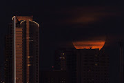 A super moon, known as the Blue Moon, is obscured by clouds as it rises above the city of San Diego, California, US, August 30, 2023.  