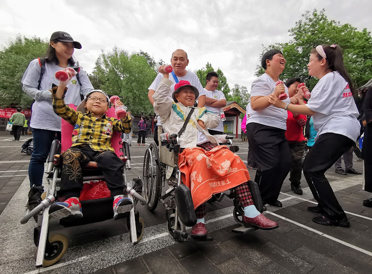 People with disabilities participate in an outdoor fun activity in Beijing, China, May. 19, 2019.