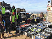 Fishermen at Pennington on the KwaZulu-Natal admire their bounty. 