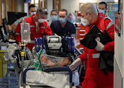 Medical personnel treat a patient infected with the coronavirus disease (Covid-19) before the patient is transferred from the CHU de Liege hospital to Germany via a medical helicopter, in Liege, Belgium November 3, 2020. 