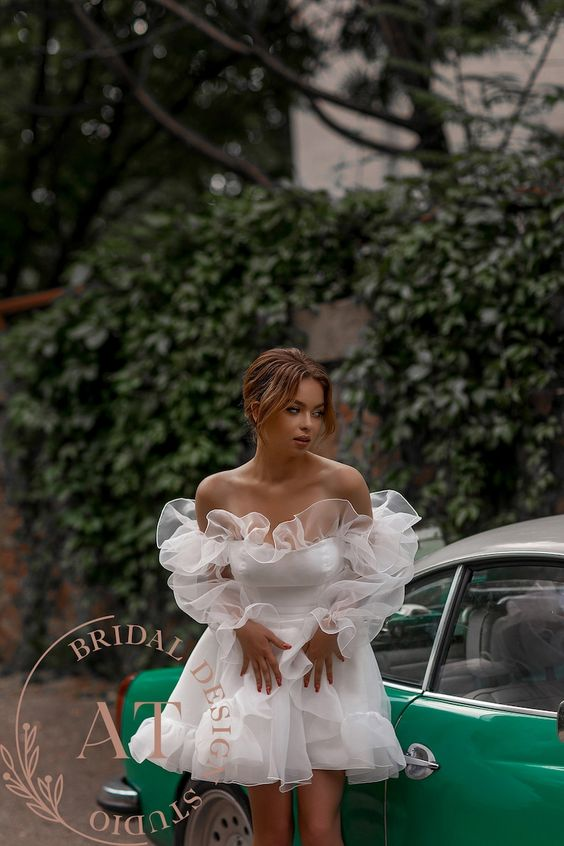 a lady wearing a short white dress as casual wedding dresses